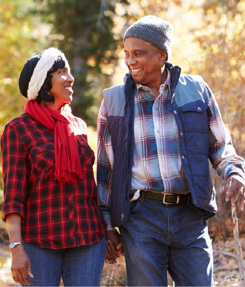 Photo of a senior couple going for a leisurely walk in the woods. Photo of a senior couple going for a leisurely walk in the woods.