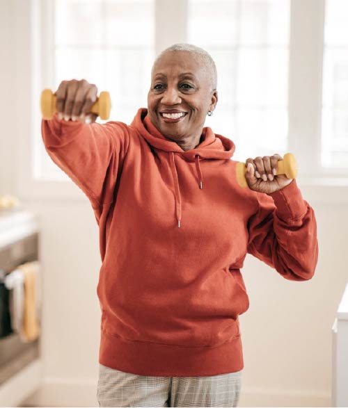 Photo of senior woman exercising with handheld weights.